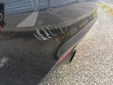 a close up of a car ' s exhaust pipe on the street