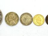 an image of a row of different coins on a white surface