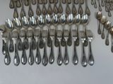 a lot of silver spoons and forks on the table