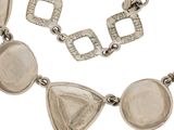 a close up of a necklace and bracelet on a white background