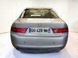 a silver car that is parked in a white room
