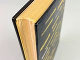 an open book sitting on top of a white table