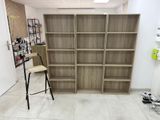 a wooden bookcase with a ladder in a room