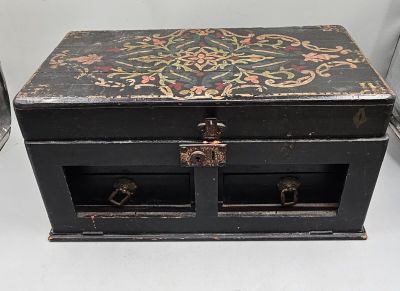 a small black box with a floral design on it