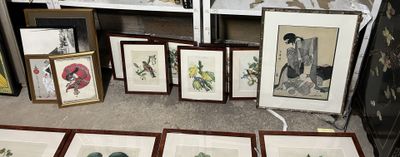 a lot of framed pictures on the floor of a room