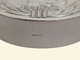 a close up of a silver coin on a white background