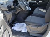 the interior of a car with the door open and the driver ' s seat down