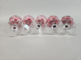 six wine glasses with red and white designs on them sitting on a white surface