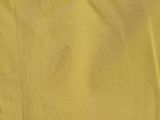 a close up picture of a yellow shirt and a pair of pants