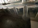 stainless steel counter top with three glass doors and a counter top with a glass door