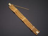 a gold bracelet with a chain and clasp