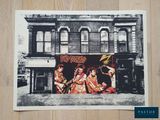 an old photo of a group of people in front of a building