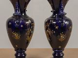two vases that are sitting on a table