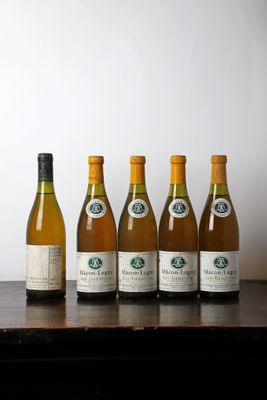 six bottles of wine are lined up on a wooden table