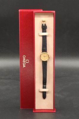 an image of a black and gold watch in a red box