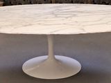a white table with a marble top in a living room