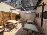 tables and chairs on the patio of a building