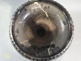 a close up of a metal object on a white surface