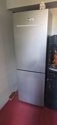 an image of a refrigerator in a kitchen with a red floor