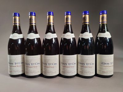 six bottles of wine are lined up in a row on a table