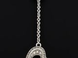 a diamond heart pendant on a chain on a black background