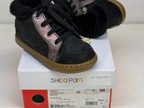 pair of black and pink shoes sitting on top of a white box