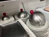 many plates and pans stacked on top of each other in the kitchen
