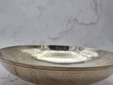 an image of a silver bowl on a marble surface