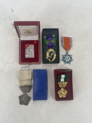 a small box of medals and other items on a table