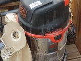 a vacuum that is sitting on a wooden bench