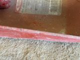 a plastic container with a strawberry inside of it on the floor