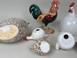 many different types of ceramic figurines displayed on the table