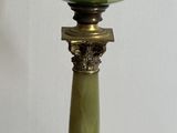a green glass lamp that is sitting on a glass table
