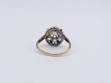 a close up of a diamond ring on a white surface