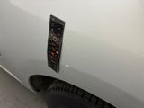 a remote control on the side of a white car