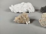 three different types of crystals are displayed on a white surface