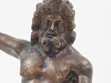 a statue of a man holding a frisbee in his hand