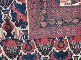 a close up of a red, blue and white rug with a pattern on it