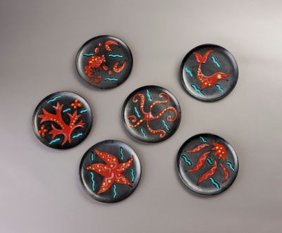six aimants en verre ornés de motifs rouges et bleus sur un fond blanc