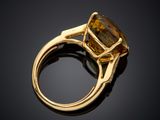 a close up view of a ring with a large citrine stone