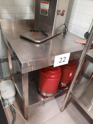 two red buckets sitting on a stainless steel table