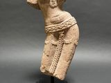 an ancient statue of a woman with a hat on her head