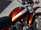 a close up of a red motorcycle parked on the street