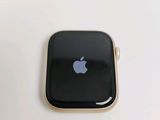 an apple watch sitting on top of a white table next to a cup of coffee