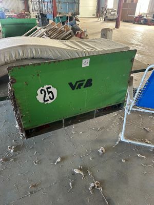 a green box sitting in the middle of a warehouse