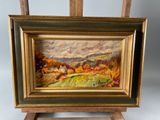 an oil painting of a landscape on a easel with a bird flying over it
