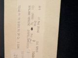 a label on the back of a jacket that has a tag attached to it