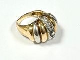 an image of a gold and diamond ring on a white surface
