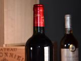 several bottles of wine sitting on a table next to a wooden box