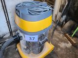a yellow and gray vacuum sitting in a room